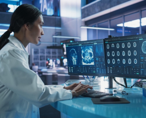 Professional In Lab Researching Brain Scans On Computer