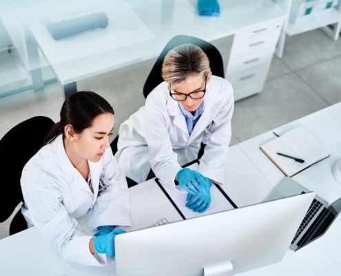 Researchers In Lab Looking At Computer