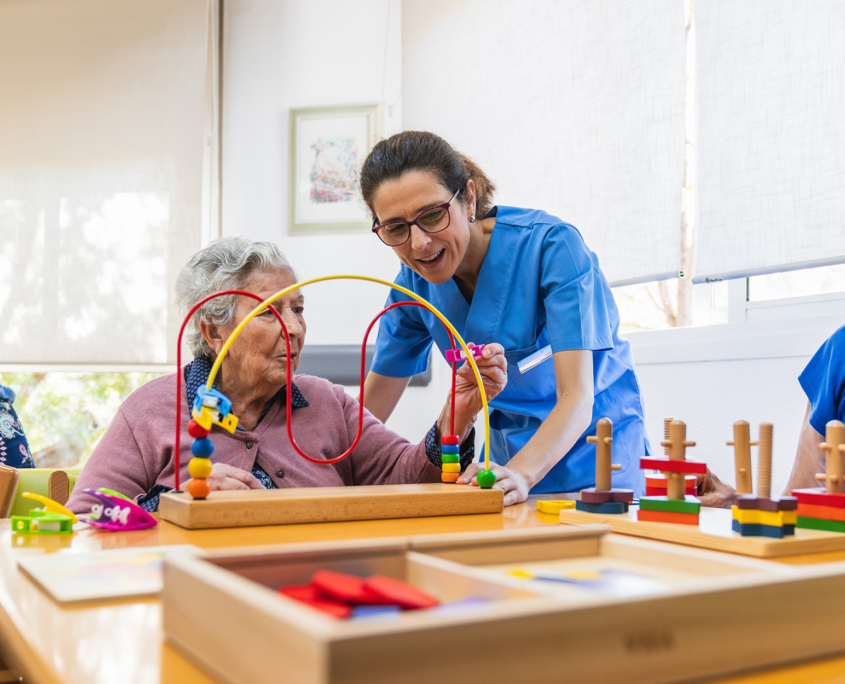 Caretaker Helping Patient With Task